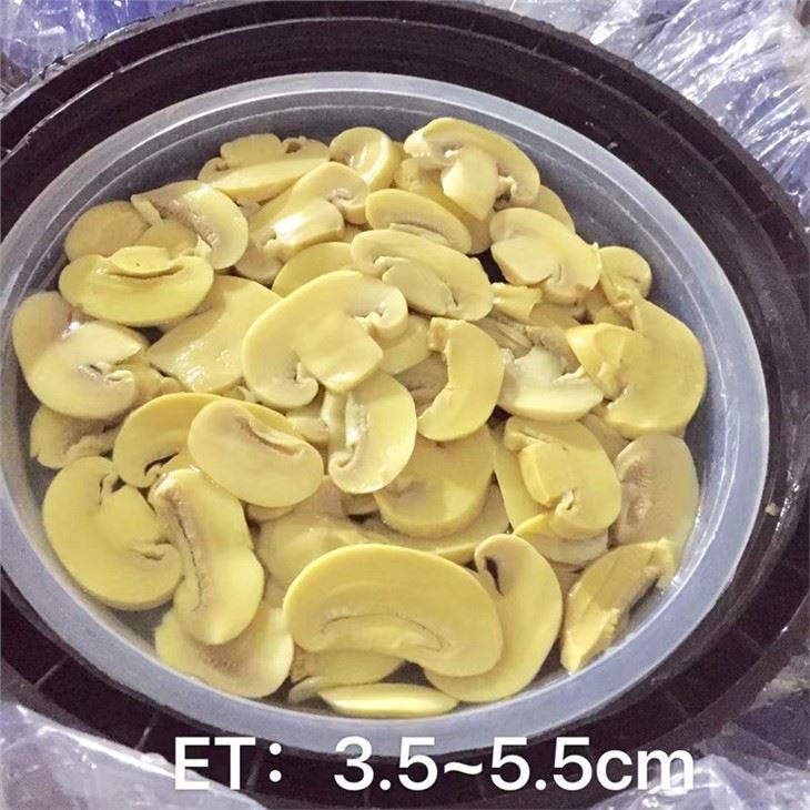 Sliced white mushroom in salted water in drums